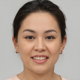 Joyful asian young-adult female with medium  brown hair and brown eyes