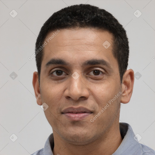 Joyful latino young-adult male with short  black hair and brown eyes