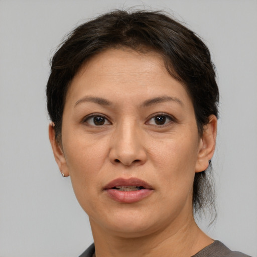 Joyful asian adult female with short  brown hair and brown eyes