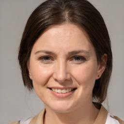 Joyful white adult female with medium  brown hair and brown eyes