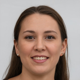 Joyful white young-adult female with long  brown hair and grey eyes