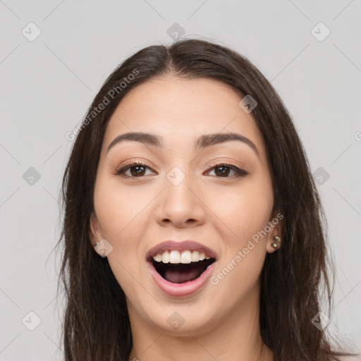 Joyful white young-adult female with long  brown hair and brown eyes