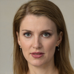 Joyful white young-adult female with long  brown hair and green eyes