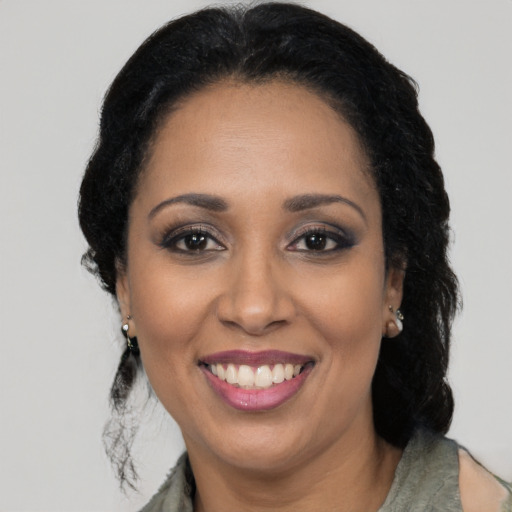 Joyful latino adult female with long  brown hair and brown eyes