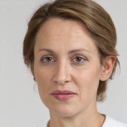 Joyful white adult female with medium  brown hair and grey eyes