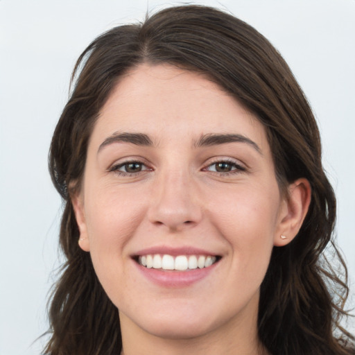 Joyful white young-adult female with long  brown hair and grey eyes