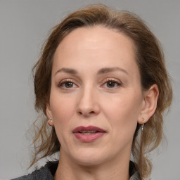 Joyful white adult female with medium  brown hair and brown eyes