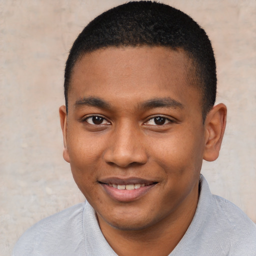 Joyful black young-adult male with short  brown hair and brown eyes