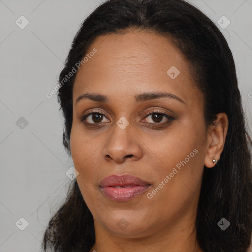 Joyful black young-adult female with long  black hair and brown eyes