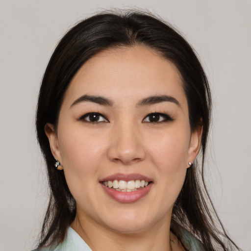Joyful latino young-adult female with medium  brown hair and brown eyes