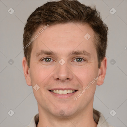 Joyful white young-adult male with short  brown hair and grey eyes