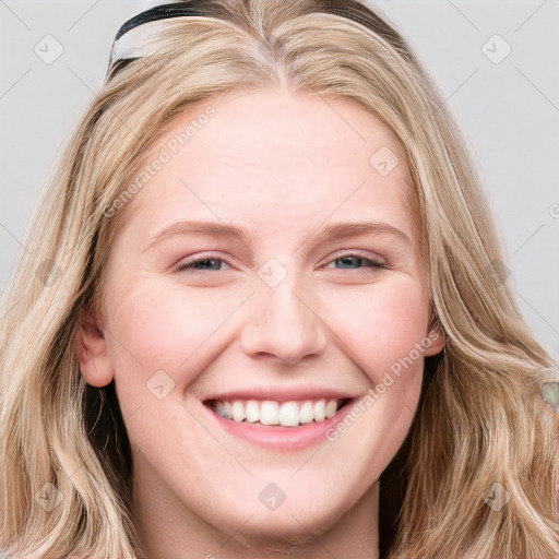 Joyful white young-adult female with long  brown hair and blue eyes