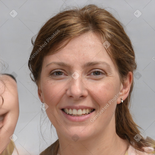 Joyful white adult female with medium  brown hair and grey eyes