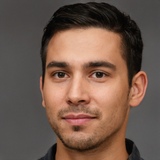 Joyful white young-adult male with short  brown hair and brown eyes