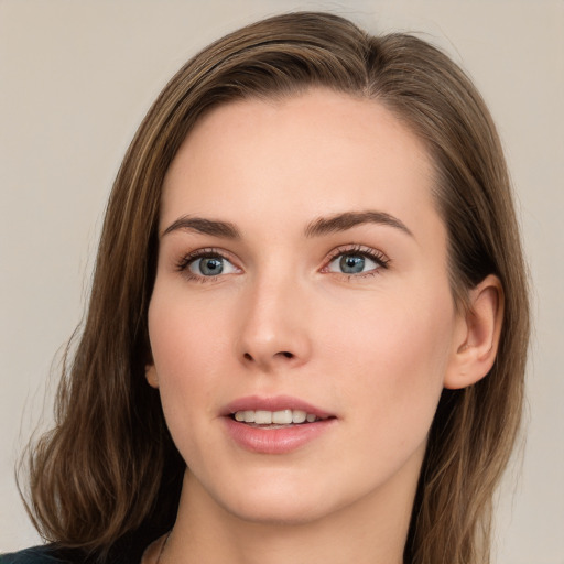 Joyful white young-adult female with long  brown hair and grey eyes