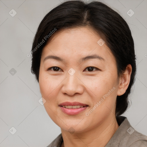 Joyful asian adult female with medium  brown hair and brown eyes