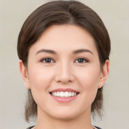 Joyful white young-adult female with medium  brown hair and brown eyes