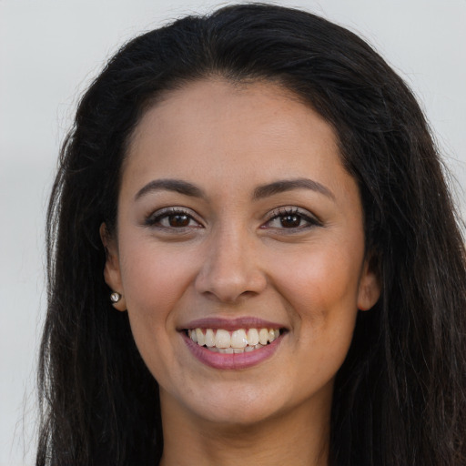 Joyful latino young-adult female with long  brown hair and brown eyes