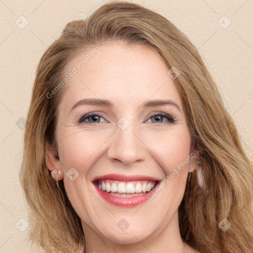 Joyful white young-adult female with long  brown hair and green eyes