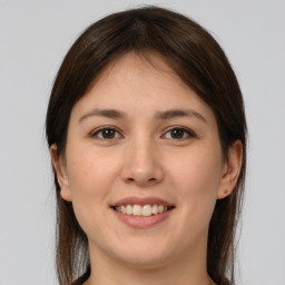 Joyful white young-adult female with medium  brown hair and brown eyes