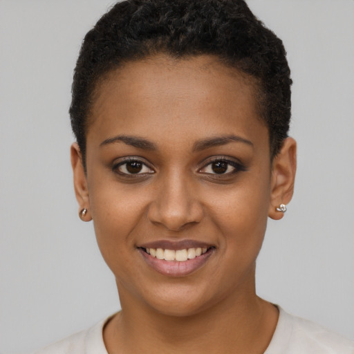 Joyful black young-adult female with short  brown hair and brown eyes