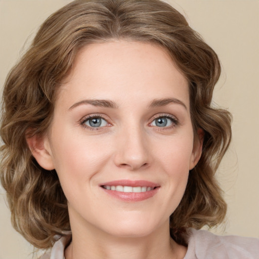 Joyful white young-adult female with medium  brown hair and green eyes