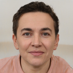 Joyful white adult male with short  brown hair and brown eyes