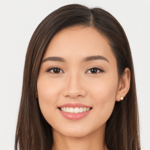 Joyful white young-adult female with long  brown hair and brown eyes