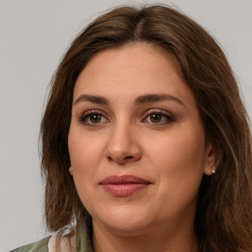 Joyful white young-adult female with long  brown hair and green eyes