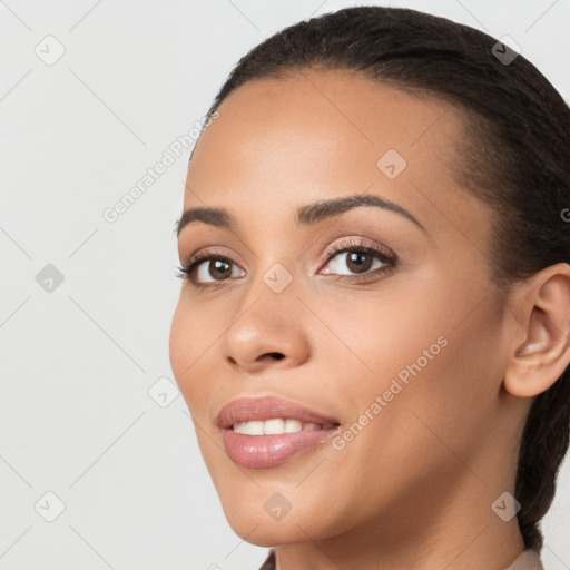 Joyful latino young-adult female with long  brown hair and brown eyes