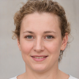 Joyful white young-adult female with medium  brown hair and blue eyes