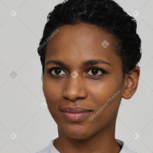 Joyful black young-adult female with short  black hair and brown eyes