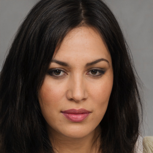 Joyful latino young-adult female with long  brown hair and brown eyes