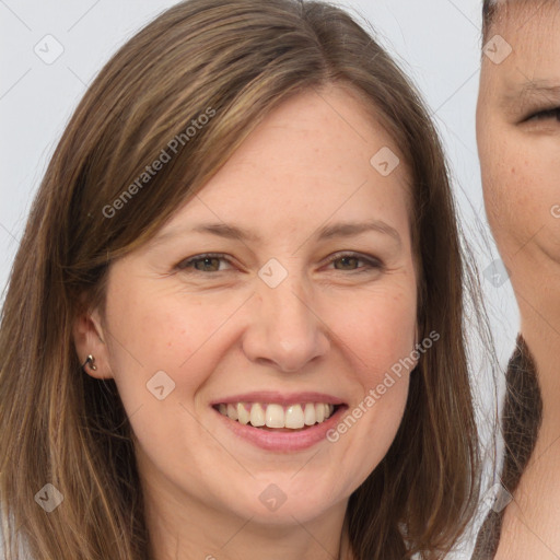 Joyful white adult female with long  brown hair and brown eyes