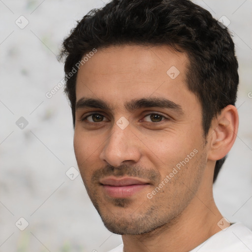 Joyful white young-adult male with short  black hair and brown eyes