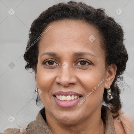 Joyful black adult female with medium  brown hair and brown eyes