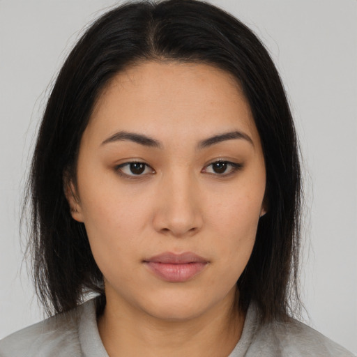 Neutral asian young-adult female with medium  brown hair and brown eyes