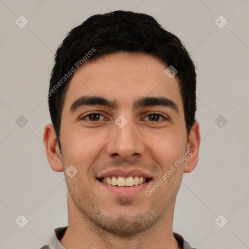 Joyful white young-adult male with short  black hair and brown eyes