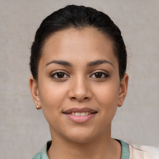 Joyful latino young-adult female with short  brown hair and brown eyes