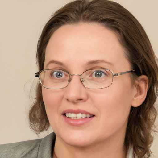 Joyful white adult female with medium  brown hair and blue eyes