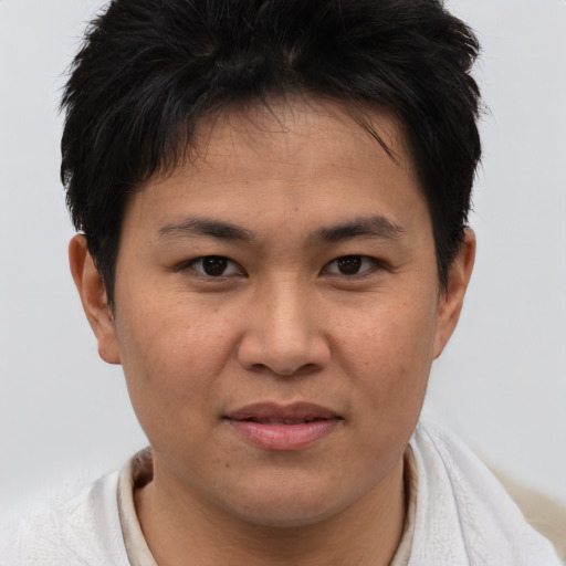 Joyful asian young-adult male with short  brown hair and brown eyes