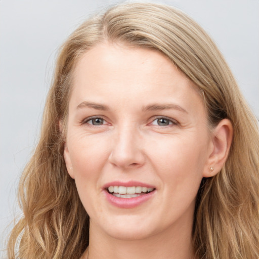 Joyful white young-adult female with long  brown hair and blue eyes