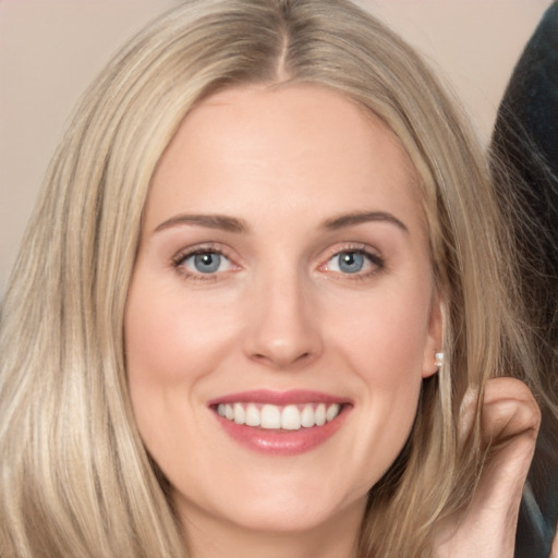 Joyful white young-adult female with long  brown hair and grey eyes