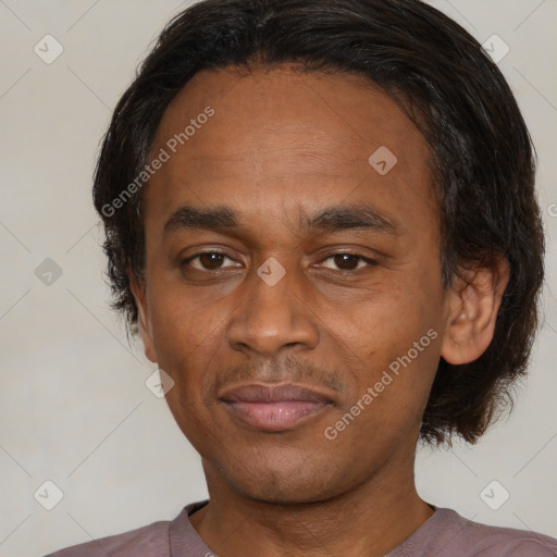 Joyful latino adult male with short  black hair and brown eyes