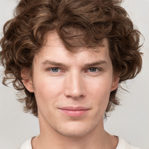 Joyful white young-adult male with medium  brown hair and brown eyes