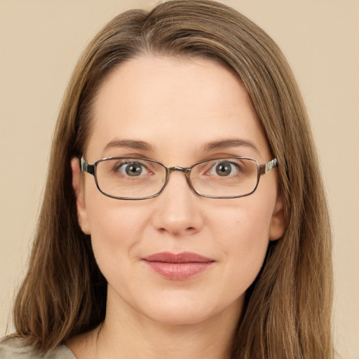 Joyful white young-adult female with long  brown hair and green eyes