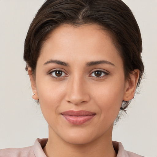 Joyful white young-adult female with medium  brown hair and brown eyes