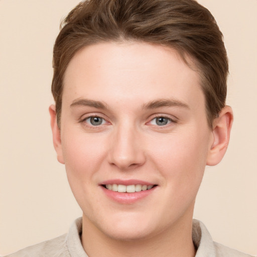 Joyful white young-adult female with short  brown hair and grey eyes