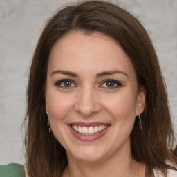 Joyful white adult female with long  brown hair and brown eyes