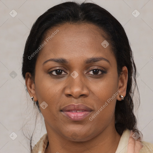 Joyful black adult female with medium  brown hair and brown eyes